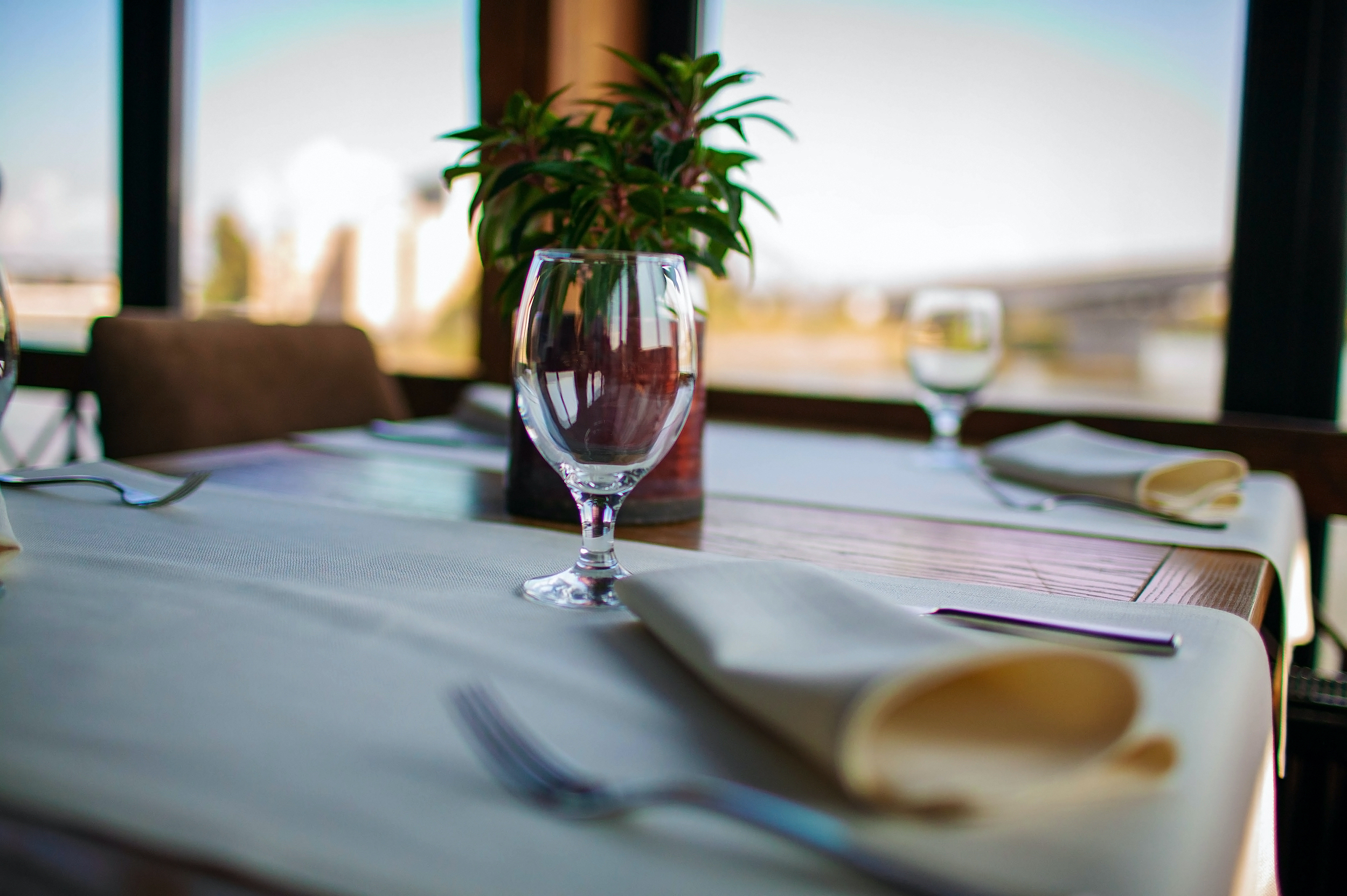 Luxury Banquet Table Setting In Restaurant Close-up. Plates And Dishes On Dining Table In Big Hall.